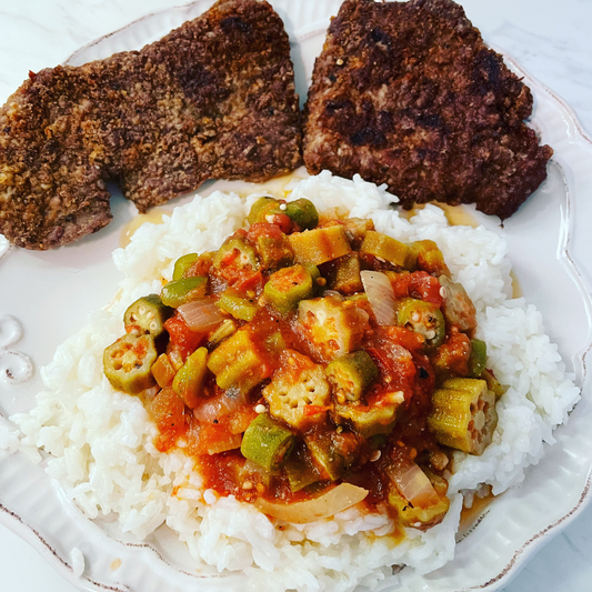 Okree and tomatoes over white rice with fried cubed steak